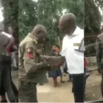 A security guard arrests a police officer for allegedly extorting a driver [Video]